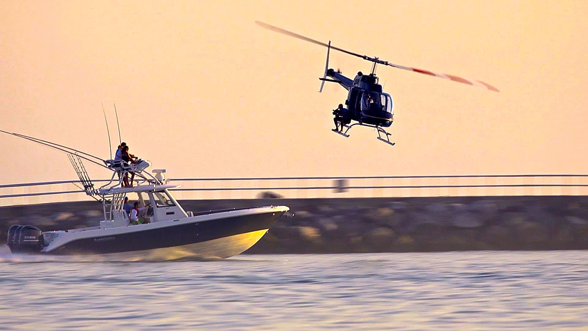 Helicopter camera crew filming a speeding boat for Slater Productions