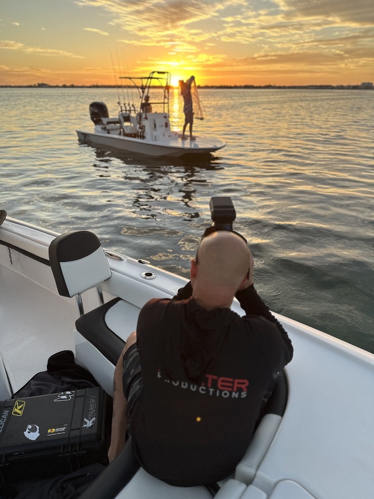 JJ Slater photographing a boat at sunset during a Slater Productions shoot